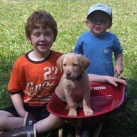 Blake and Seth Miessner with the family puppy