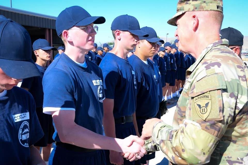U.S. Army officer shaking hands at a youth leadership ceremony